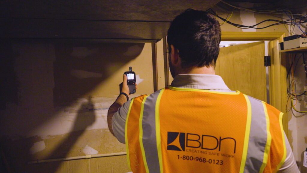 A BDN employee testing for hazardous and toxic building materials.